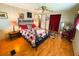 Bedroom featuring wood floors, decorative accents, and closet at 313 Palo Verde Dr, Leesburg, FL 34748