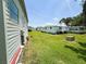 Side view of single-story homes and manicured lawn at 313 Palo Verde Dr, Leesburg, FL 34748