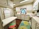 Traditional kitchen with white appliances, cabinets, countertops, hard wood floor, and entry door in a cozy home at 313 Palo Verde Dr, Leesburg, FL 34748