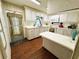 Traditional kitchen with white appliances, cabinets, countertops, hard wood floor, and entry door in a cozy home at 313 Palo Verde Dr, Leesburg, FL 34748