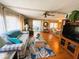 Traditional living room with hardwood flooring, decor, furniture, sliding glass door and natural lighting in a cozy home at 313 Palo Verde Dr, Leesburg, FL 34748