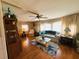 Traditional living room with hardwood flooring, decor, furniture, and natural lighting in a cozy home at 313 Palo Verde Dr, Leesburg, FL 34748