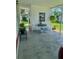 Covered patio area with outdoor seating, creating a cozy and inviting space to relax outdoors at 313 Palo Verde Dr, Leesburg, FL 34748
