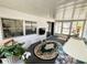 Well-lit sun room offering comfortable seating, a television, large windows, and sliding glass door access at 313 Palo Verde Dr, Leesburg, FL 34748