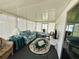 Relaxing sun room with an area rug, comfortable seating, and plenty of natural light at 313 Palo Verde Dr, Leesburg, FL 34748