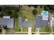 Bird's-eye view of a home surrounded by a spacious yard and neighboring houses, including one with a swimming pool at 4514 Crichton Ln, Orlando, FL 32806