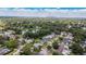 Panoramic aerial view of a residential neighborhood showcasing tree-lined streets, homes, and a distant city skyline at 4514 Crichton Ln, Orlando, FL 32806