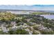 Expansive aerial shot capturing a residential area with views of homes, lush trees, and a serene lake in the distance at 4514 Crichton Ln, Orlando, FL 32806