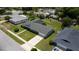 Aerial shot of a residential property highlighting the house, driveway, and proximity to other homes, one with a pool at 4514 Crichton Ln, Orlando, FL 32806