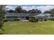 Expansive backyard with lush green grass, mature trees, and well-maintained landscaping at 4514 Crichton Ln, Orlando, FL 32806