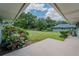 Backyard with a concrete patio, landscaping, and a view of the lush green grass and trees at 4514 Crichton Ln, Orlando, FL 32806