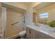 Well-lit bathroom featuring tiled shower with safety bars and modern vanity with ample counter space at 4514 Crichton Ln, Orlando, FL 32806