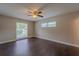 Spacious bedroom with beautiful dark wood floors and a ceiling fan providing ample ventilation at 4514 Crichton Ln, Orlando, FL 32806