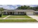 Charming single-story home features a well-manicured lawn, tidy landscaping, and an attached two-car garage at 4514 Crichton Ln, Orlando, FL 32806