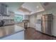 Modern kitchen featuring stainless steel appliances, white cabinets, and dark wood flooring at 4514 Crichton Ln, Orlando, FL 32806