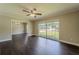 Comfortable living room with large window, hardwood floors, and a ceiling fan at 4514 Crichton Ln, Orlando, FL 32806