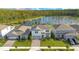 An aerial view of a neighborhood showcasing a two-story home, and pond views at 6066 Arbor Watch Loop, Orlando, FL 32829