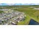 Extensive view of a new construction community with a lake and wooded preserve at 6066 Arbor Watch Loop, Orlando, FL 32829
