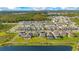 Panoramic aerial view of a neighborhood bordering a tranquil lake and conservation area at 6066 Arbor Watch Loop, Orlando, FL 32829
