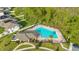 Aerial view showing a community pool with lounge chairs at 6066 Arbor Watch Loop, Orlando, FL 32829