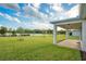 A beautiful backyard with a pond view is seen from the patio of this gorgeous house at 6066 Arbor Watch Loop, Orlando, FL 32829