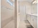 Bathroom showcasing tiled walk-in shower and double vanity with modern fixtures and design at 6066 Arbor Watch Loop, Orlando, FL 32829