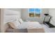 Simple bedroom featuring a modern bed frame, neutral color palette, and a window view at 6066 Arbor Watch Loop, Orlando, FL 32829