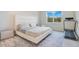 Minimal bedroom featuring a modern bed frame, neutral color palette, and a window view at 6066 Arbor Watch Loop, Orlando, FL 32829