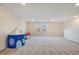 Bright bonus room with neutral carpet, a play tent, and natural light at 6066 Arbor Watch Loop, Orlando, FL 32829
