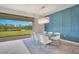 Dining room area with decorative blue wall paneling and sliding glass doors at 6066 Arbor Watch Loop, Orlando, FL 32829