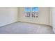 Empty room features neutral carpet and natural light from the double window at 6066 Arbor Watch Loop, Orlando, FL 32829