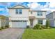 Charming two-story home with a well-manicured lawn and a two car garage at 6066 Arbor Watch Loop, Orlando, FL 32829