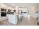 Modern kitchen with stainless steel appliances, white cabinets, tiled backsplash and an island with barstool seating at 6066 Arbor Watch Loop, Orlando, FL 32829