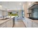 Bright kitchen boasts stone countertops, an island with sink, and backyard views from the breakfast nook at 6066 Arbor Watch Loop, Orlando, FL 32829
