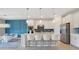 Spacious open concept kitchen featuring a large island with seating and stainless appliances at 6066 Arbor Watch Loop, Orlando, FL 32829