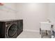 The laundry room features a modern washer and dryer set with a utility sink, and a wire rack shelf at 6066 Arbor Watch Loop, Orlando, FL 32829