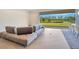 Sofa overlooks the lake view through the sliding glass doors at 6066 Arbor Watch Loop, Orlando, FL 32829