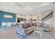 Open-concept living room and kitchen with stylish furniture and modern finishes at 6066 Arbor Watch Loop, Orlando, FL 32829