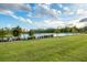 A serene view of a pond surrounded by green grass and lush trees, offering a peaceful and scenic backdrop at 6066 Arbor Watch Loop, Orlando, FL 32829