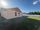 Back exterior view from backyard with a newly installed white vinyl fence at 6608 Madeira Ave, Lakeland, FL 33811