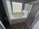 Bathroom featuring soaking tub, tile and glass block window at 6608 Madeira Ave, Lakeland, FL 33811