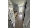 Hallway view to bathroom featuring wood floor, granite counters, and tub at 6608 Madeira Ave, Lakeland, FL 33811