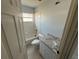 Bathroom featuring a tub, toilet, window, and vanity sink with modern hardware at 6608 Madeira Ave, Lakeland, FL 33811