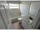 This bathroom includes a shower, a granite countertop sink, and wood look floors at 6608 Madeira Ave, Lakeland, FL 33811