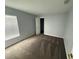 This bedroom offers a spacious layout with neutral walls, plush carpet, and a window with natural light at 6608 Madeira Ave, Lakeland, FL 33811