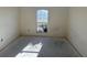 Bright bedroom featuring a large window, ready for transformation and design at 6608 Madeira Ave, Lakeland, FL 33811