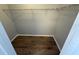 Walk-in closet featuring wood flooring and metal shelving at 6608 Madeira Ave, Lakeland, FL 33811