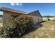 Exterior back of home with mature bushes at 6608 Madeira Ave, Lakeland, FL 33811