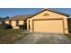 Inviting one-story home with an attached two-car garage and well-kept lawn at 6608 Madeira Ave, Lakeland, FL 33811