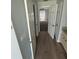 Hallway view to bedroom and bathroom featuring wood floor at 6608 Madeira Ave, Lakeland, FL 33811